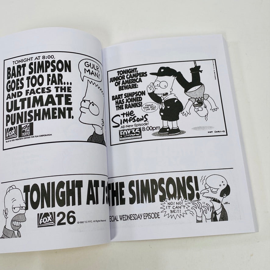 Open book with black and white cartoon-style advertisements for 'The Simpsons' on a white background