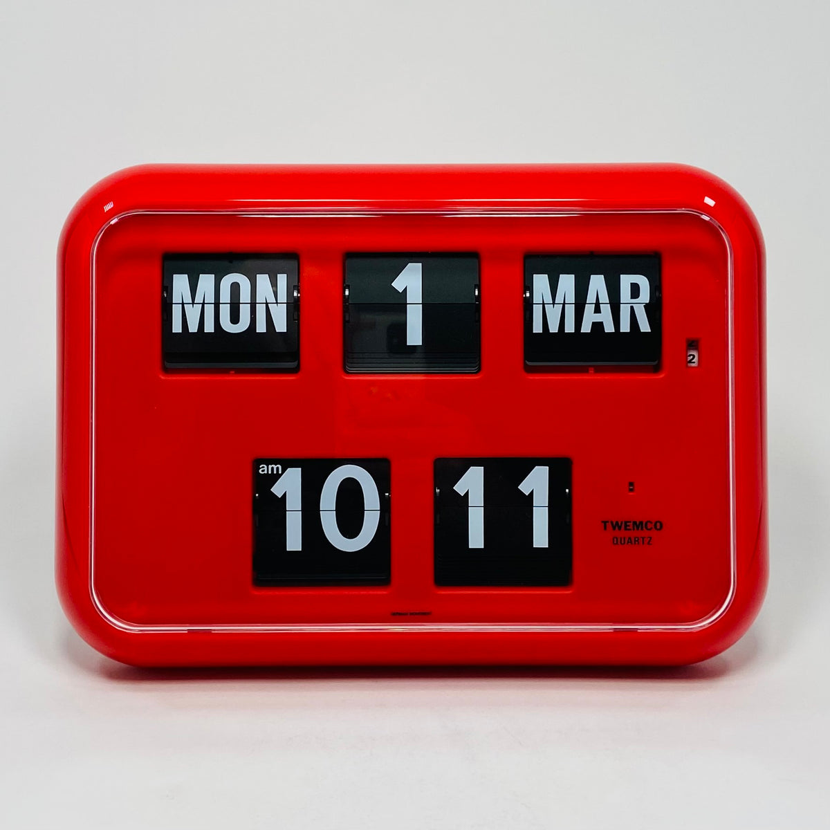 Retro red analog flip clock with perpetual calendar, vintage mechanical flip display, mid-century modern desk or wall clock