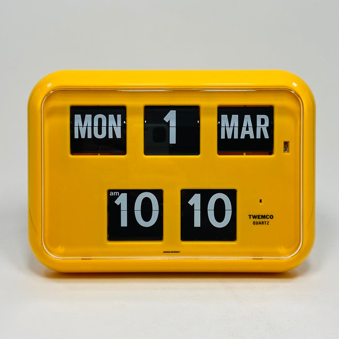 Retro yellow analog flip clock with perpetual calendar, vintage mechanical flip display, mid-century modern desk or wall clock