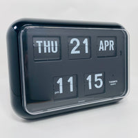 Retro black analog flip clock with perpetual calendar, vintage mechanical flip display, mid-century modern desk or wall clock