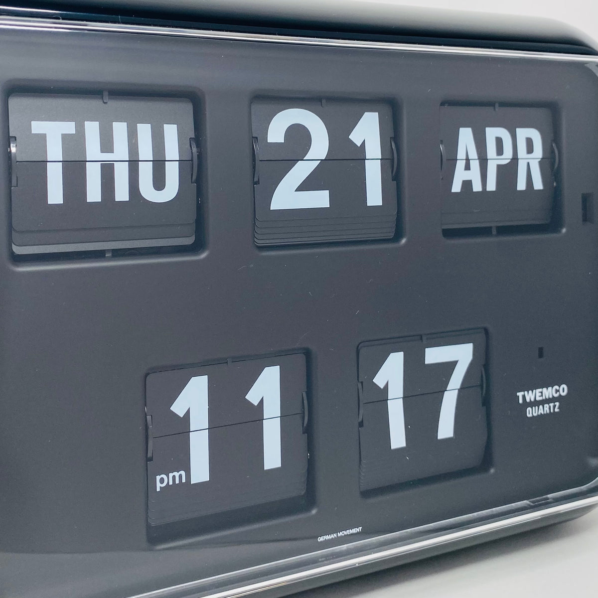 Retro black analog flip clock with perpetual calendar, vintage mechanical flip display, mid-century modern desk or wall clock
