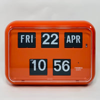 Retro orange analog flip clock with perpetual calendar, vintage mechanical flip display, mid-century modern desk or wall clock