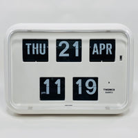 Retro white analog flip clock with perpetual calendar, vintage mechanical flip display, mid-century modern desk or wall clock