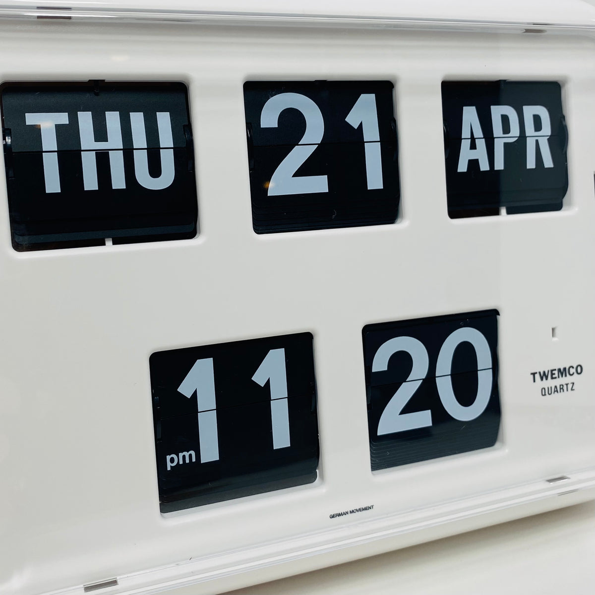 Retro white analog flip clock with perpetual calendar, vintage mechanical flip display, mid-century modern desk or wall clock