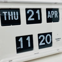 Retro white analog flip clock with perpetual calendar, vintage mechanical flip display, mid-century modern desk or wall clock
