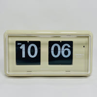 Retro beige analog flip clock, vintage mechanical flip display, mid-century modern desk or wall clock