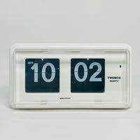 Retro white analog flip clock, vintage mechanical flip display, mid-century modern desk or wall clock