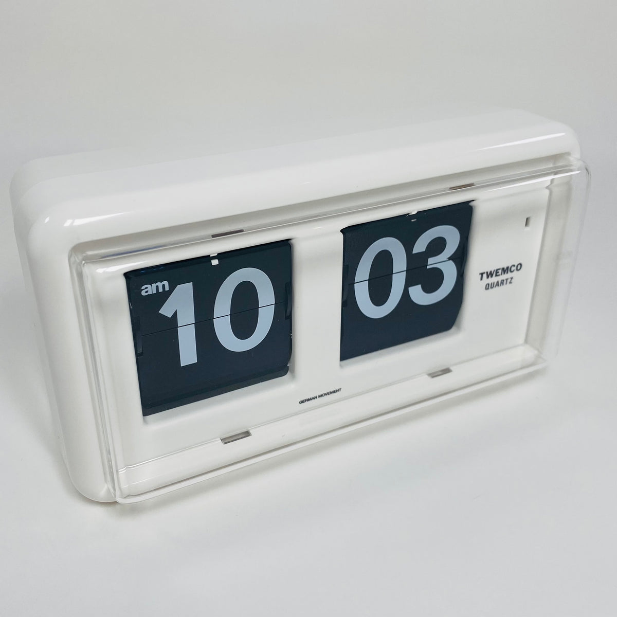 Retro white analog flip clock, vintage mechanical flip display, mid-century modern desk or wall clock