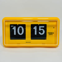 Retro yellow analog flip clock, vintage mechanical flip display, mid-century modern desk or wall clock
