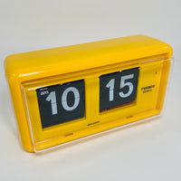 Retro yellow analog flip clock, vintage mechanical flip display, mid-century modern desk or wall clock